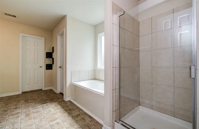 a bathroom with a bathtub and a shower