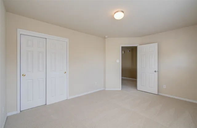 a view of an empty room with a closet