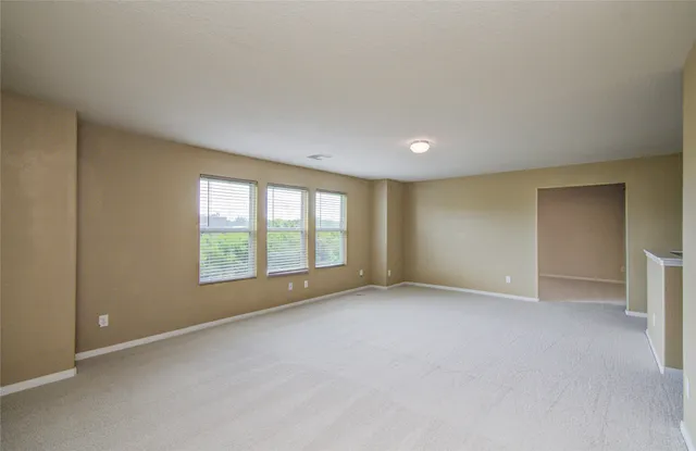 an empty room with a empty space and windows