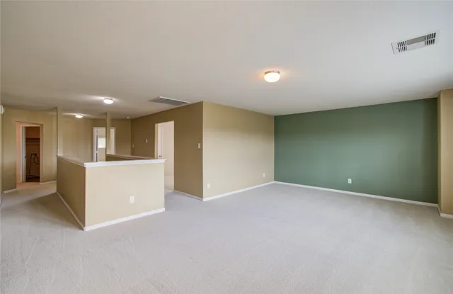 a view of an empty room with kitchen