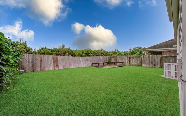 a view of a backyard with a garden and entertaining space