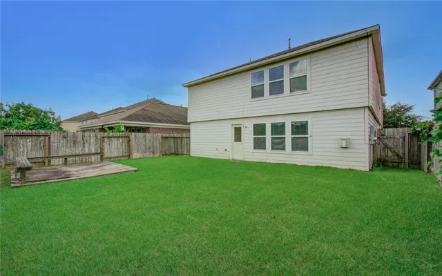 a view of an house with backyard space and garden