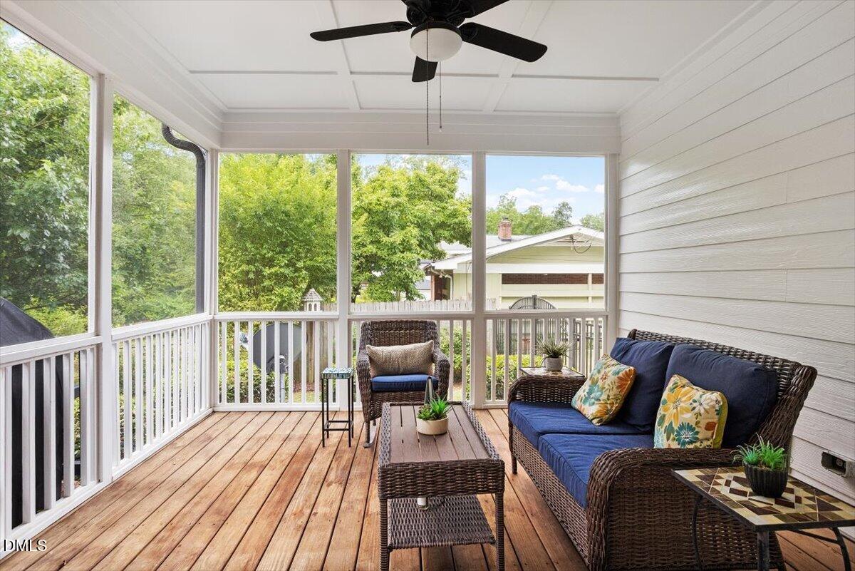 1404 Ivy Lane Raleigh, NC 27609 - Photo 9 of 37 Screened porch featuring wood-finish flooring, white shiplap walls, a coffered ceiling, and a ceiling fan