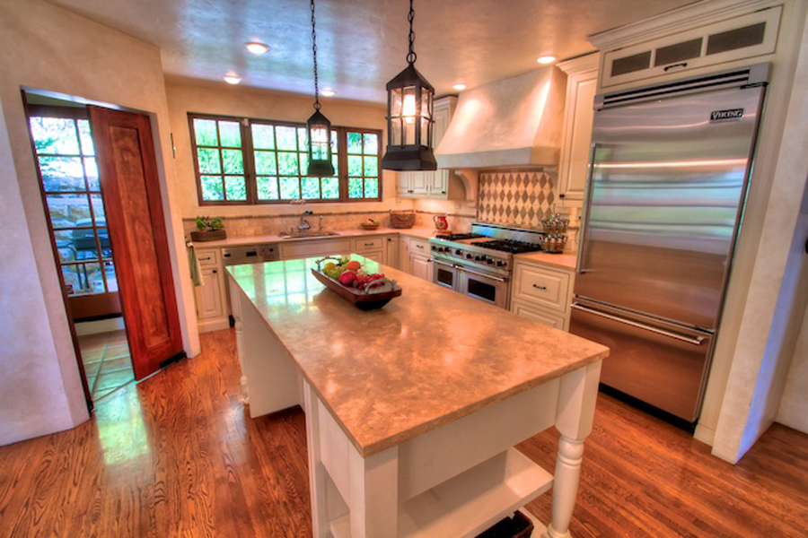1010 Garcia Road Santa Barbara, CA 93103 - Photo 5 of 20 a kitchen with a wooden floor and a refrigerator