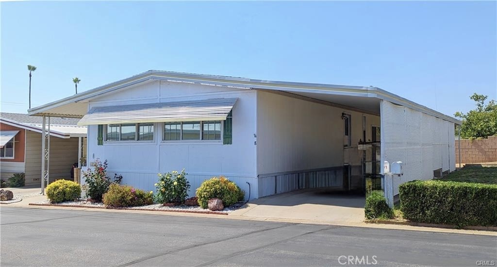 975 California Street, Unit 8 Calimesa, CA 92320 - Photo 2 of 19 a front view of a house with garage