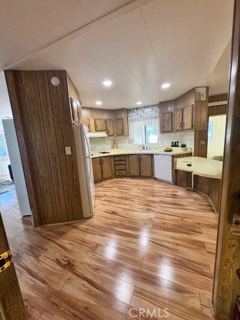 975 California Street, Unit 8 Calimesa, CA 92320 - Photo 7 of 19 a large kitchen with a refrigerator a stove top oven a sink dishwasher and wooden cabinets