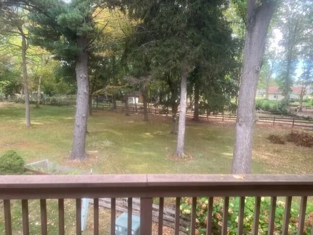 a view of room with window and flat screen tv