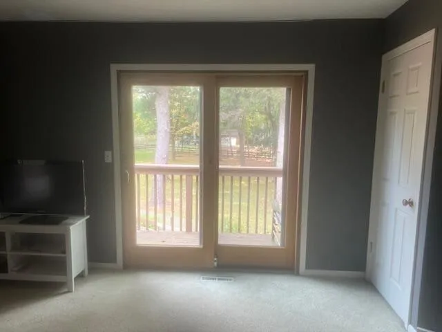 a living room with a fireplace and a flat screen tv