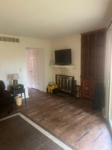 a kitchen with a sink cabinets and a wooden floor