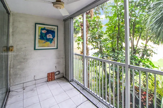 a view of a balcony with wooden floor and plants