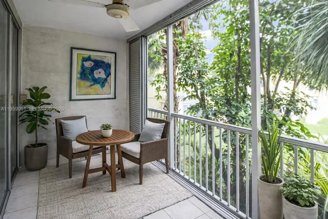 a view of a porch with furniture and a yard