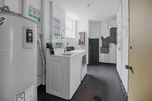 a utility room with cabinets washer and dryer