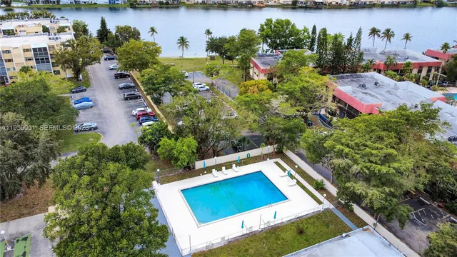 an aerial view of a house with a yard and lake view