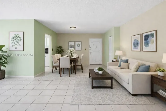 a living room with furniture and a potted plant
