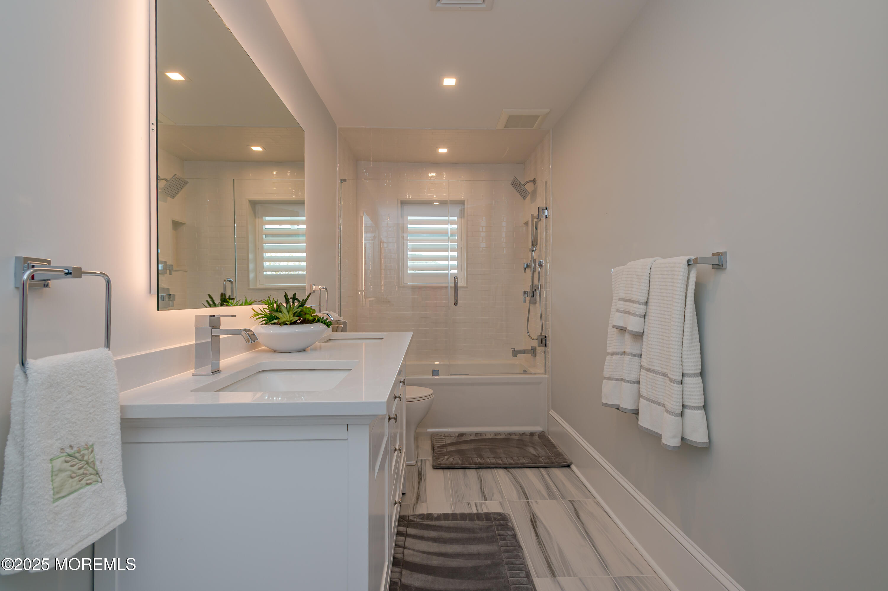 112 Passaic Avenue Spring Lake, NJ 07762 - Photo 42 of 69 a bathroom with a sink a mirror and a shower