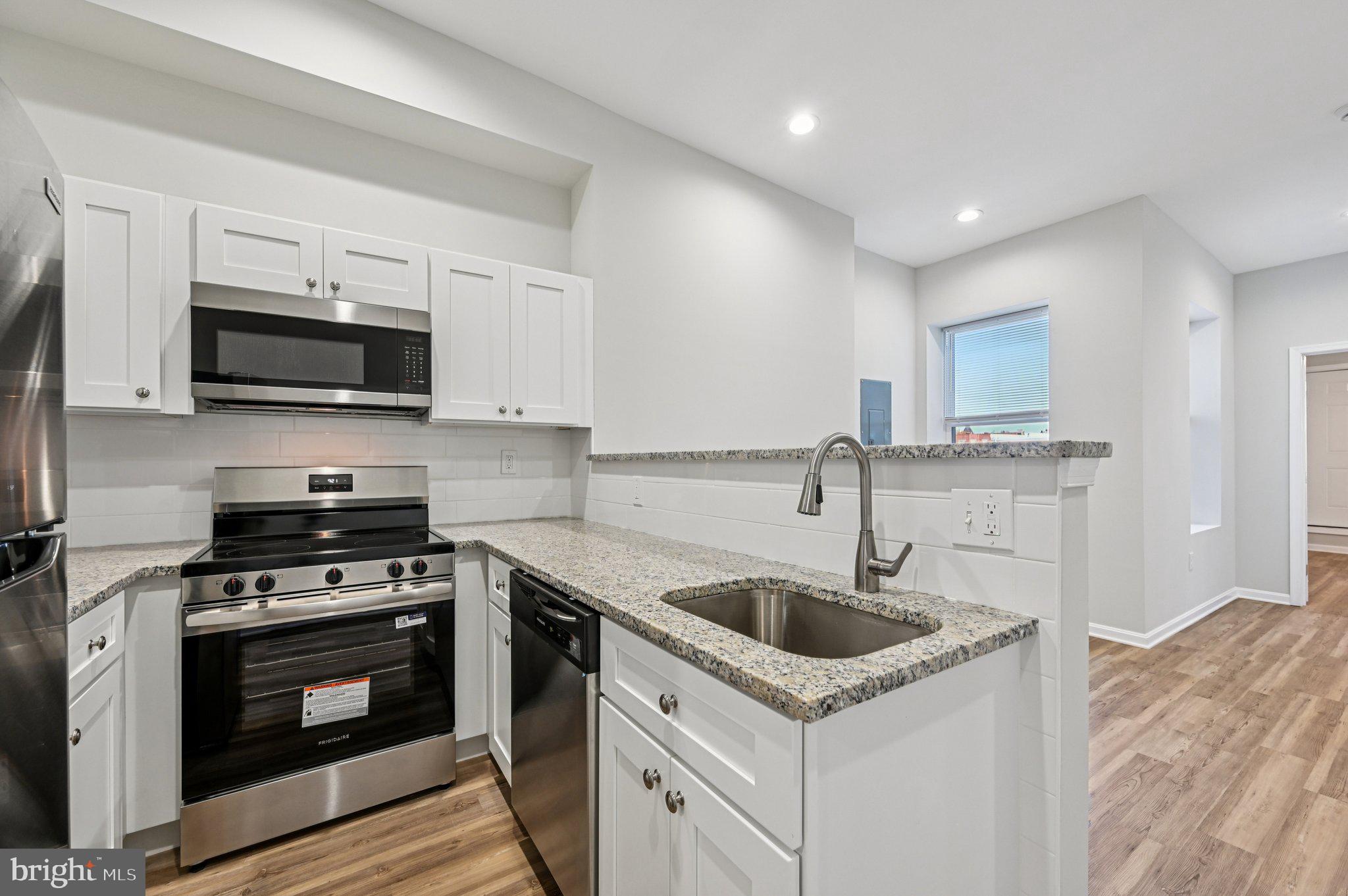 750 Reservoir Street, Unit C Baltimore, MD 21217 - Photo 12 of 25 a kitchen with granite countertop a sink and steel appliances