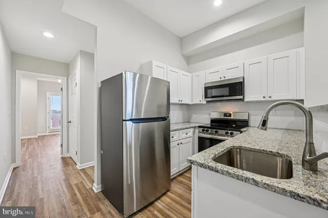 a kitchen with a refrigerator sink and microwave
