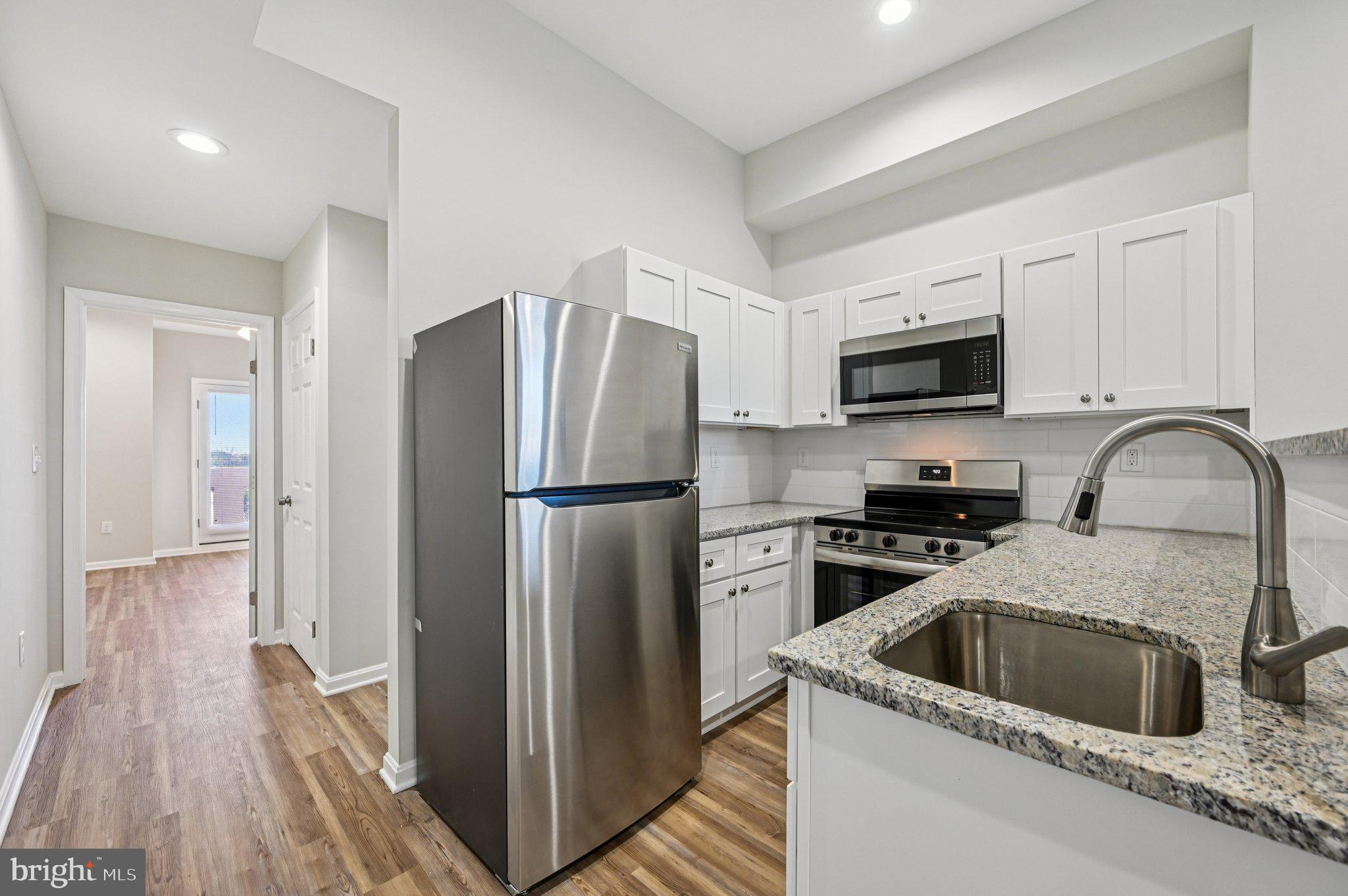 750 Reservoir Street, Unit C Baltimore, MD 21217 - Photo 13 of 25 a kitchen with a refrigerator sink and microwave