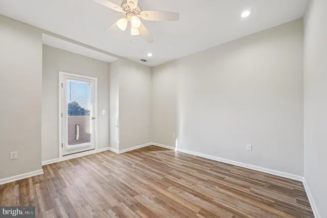 wooden floor in an empty room with a window
