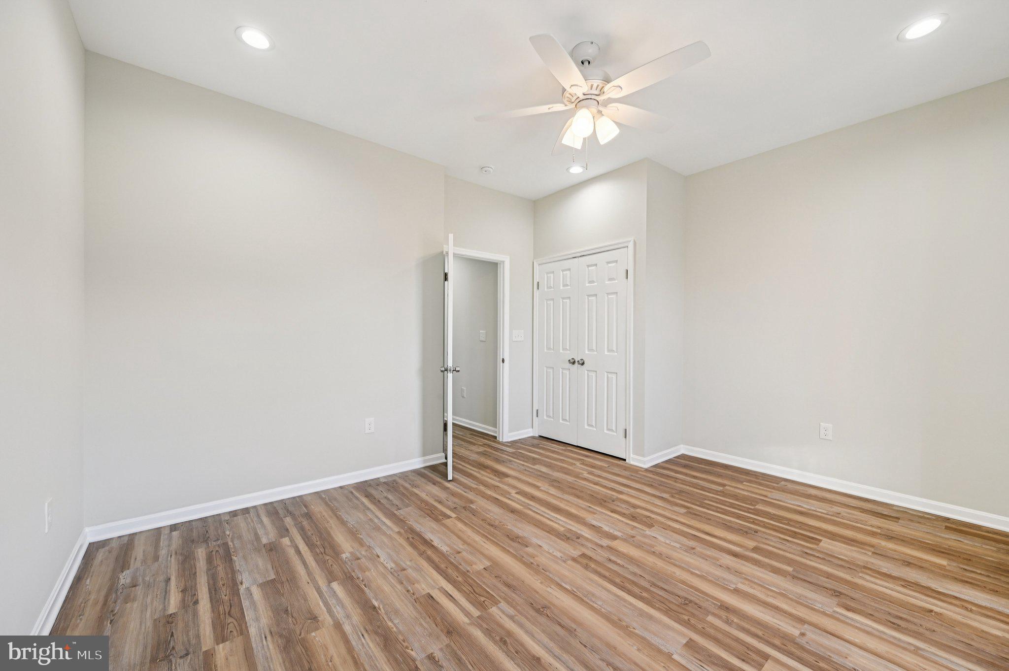 750 Reservoir Street, Unit C Baltimore, MD 21217 - Photo 18 of 25 a view of a room with wooden floor and a ceiling fan