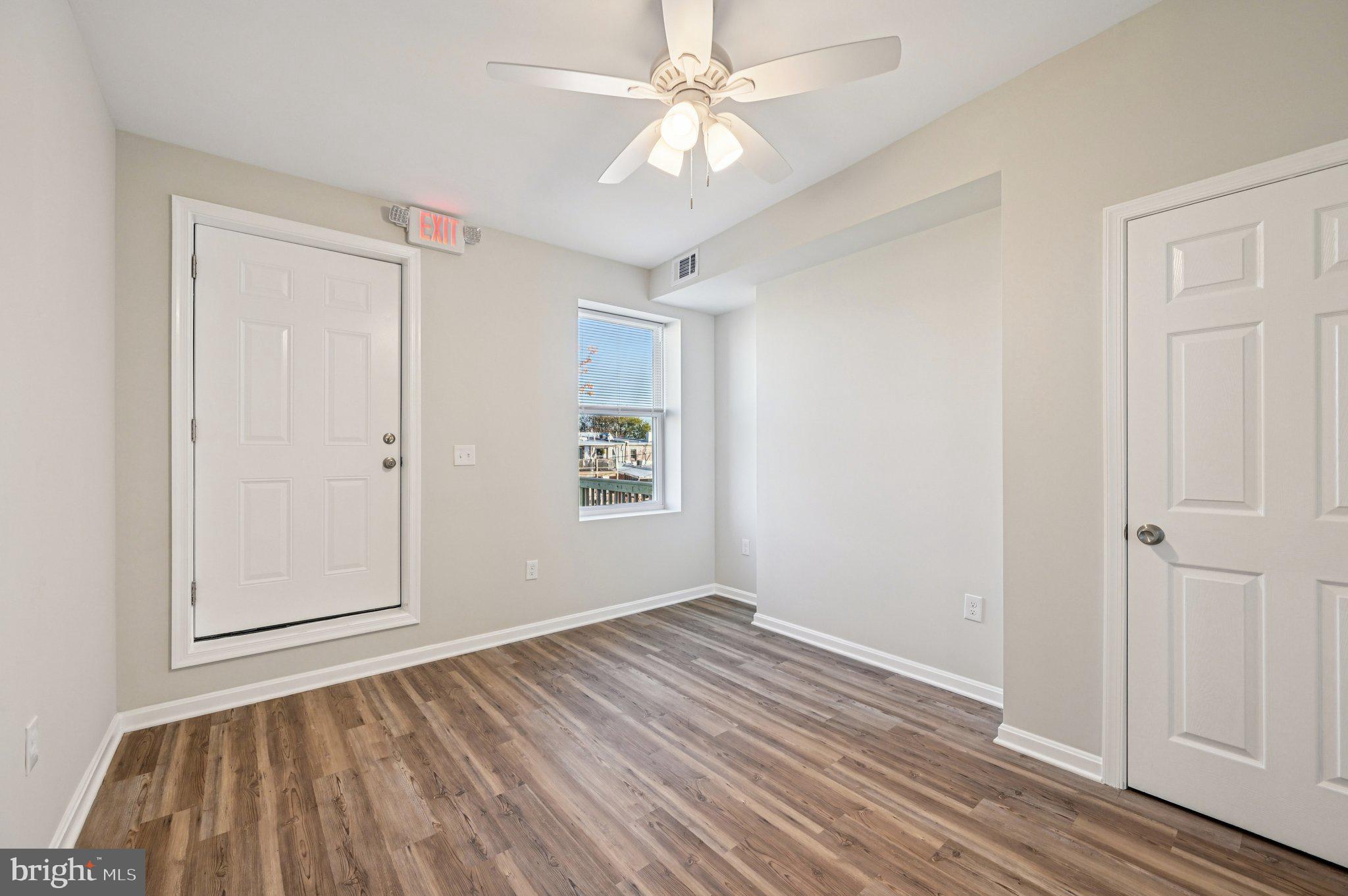 750 Reservoir Street, Unit C Baltimore, MD 21217 - Photo 19 of 25 wooden floor in an empty room with a window
