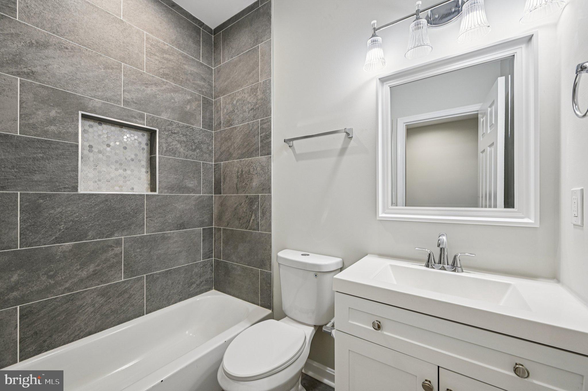 750 Reservoir Street, Unit C Baltimore, MD 21217 - Photo 22 of 25 a bathroom with a sink a toilet and shower