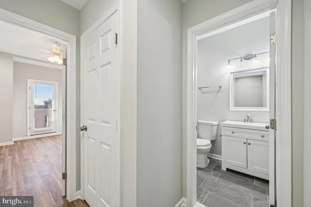 a bathroom with a double vanity sink a mirror and a toilet