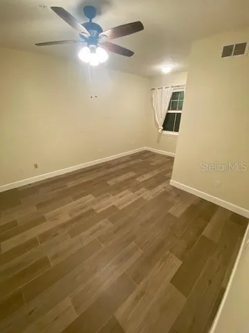 an empty room with a empty space and a ceiling fan
