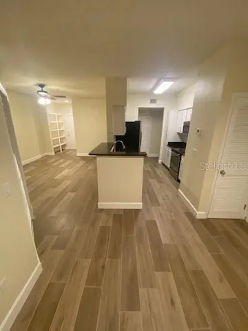 a view of a living room a room with wooden floor and furniture