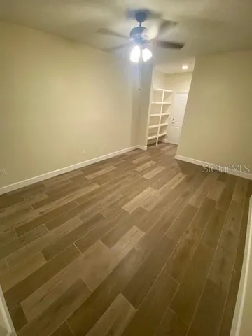an empty room with a empty space and a ceiling fan