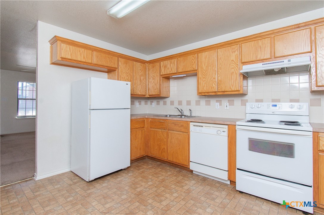 405 Bermuda Street, Unit B Copperas Cove, TX 76522 - Photo 5 of 13 a kitchen with a refrigerator sink stove and cabinets