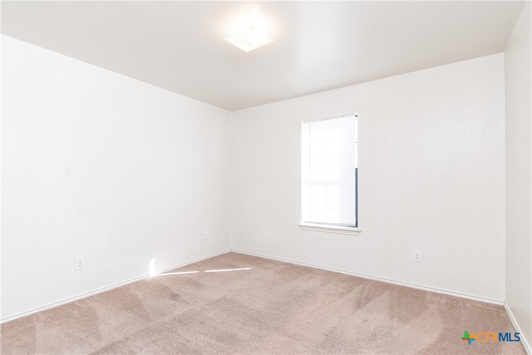 405 Bermuda Street, Unit B Copperas Cove, TX 76522 - Photo 10 of 13 an empty room with a window