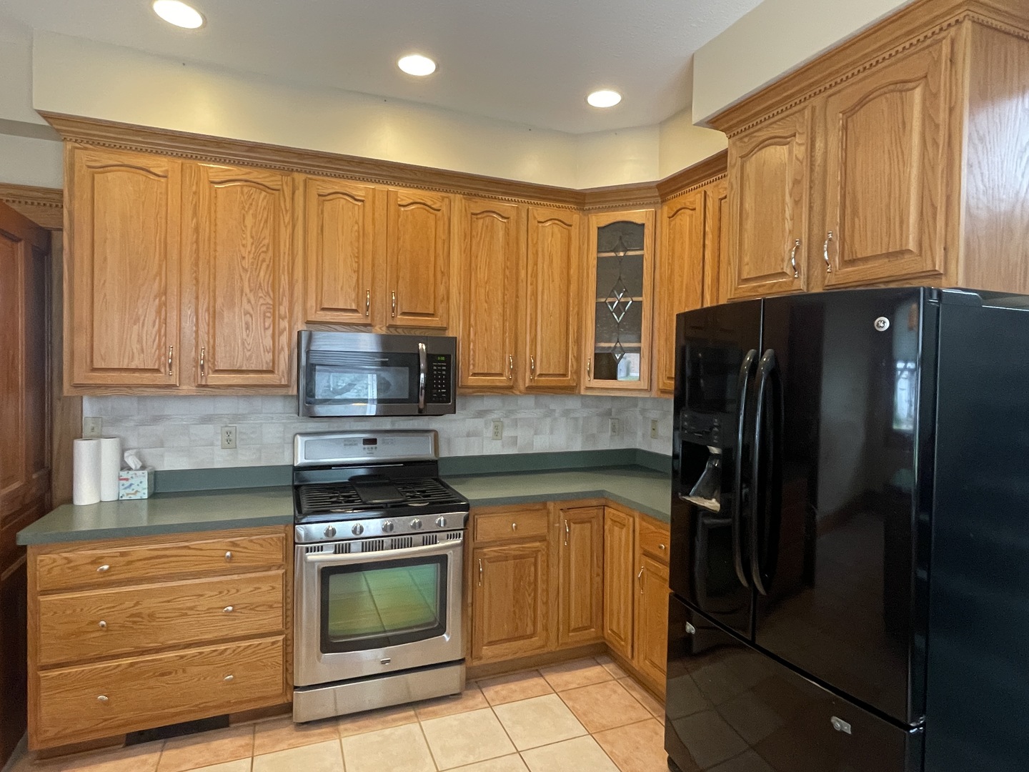322 Crawford Avenue Dixon, IL 61021 - Photo 18 of 44 a kitchen with granite countertop wooden cabinets and stainless steel appliances