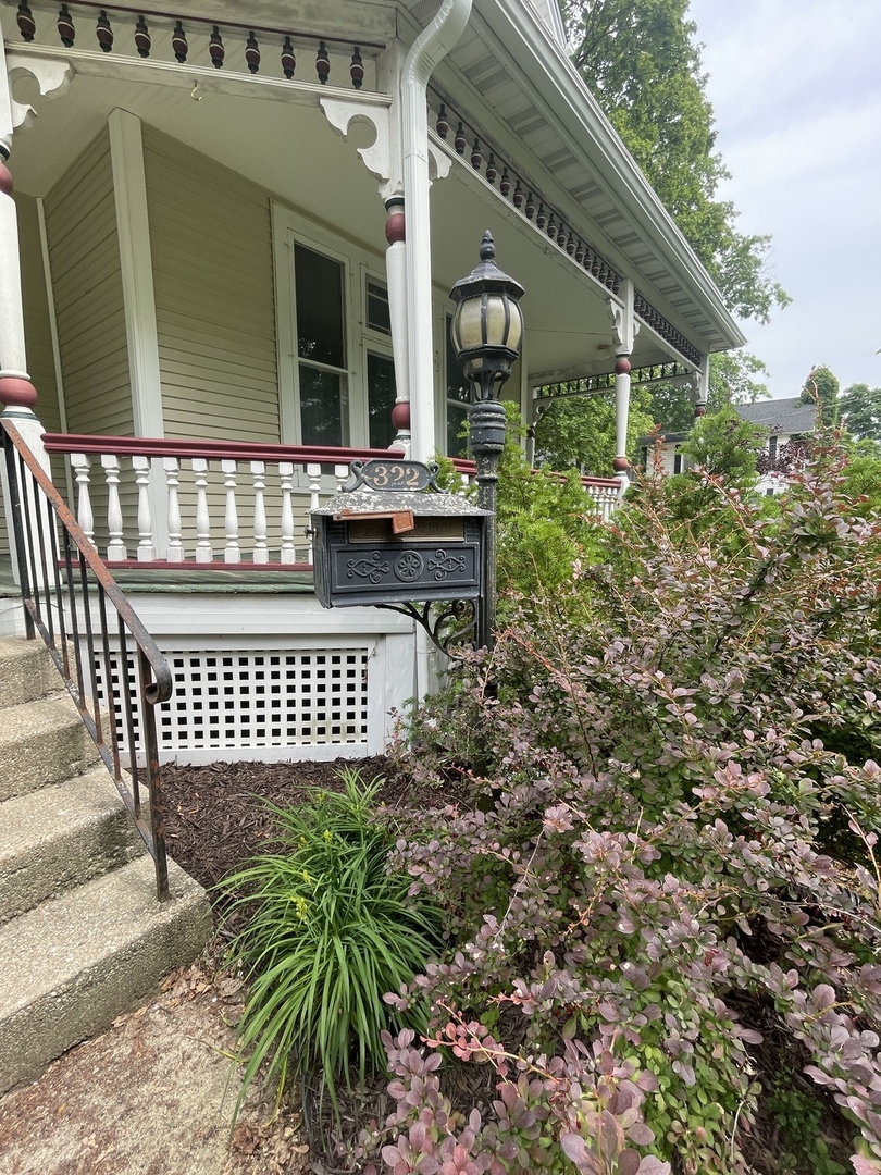 322 Crawford Avenue Dixon, IL 61021 - Photo 9 of 44 a view of a brick house with a flower garden