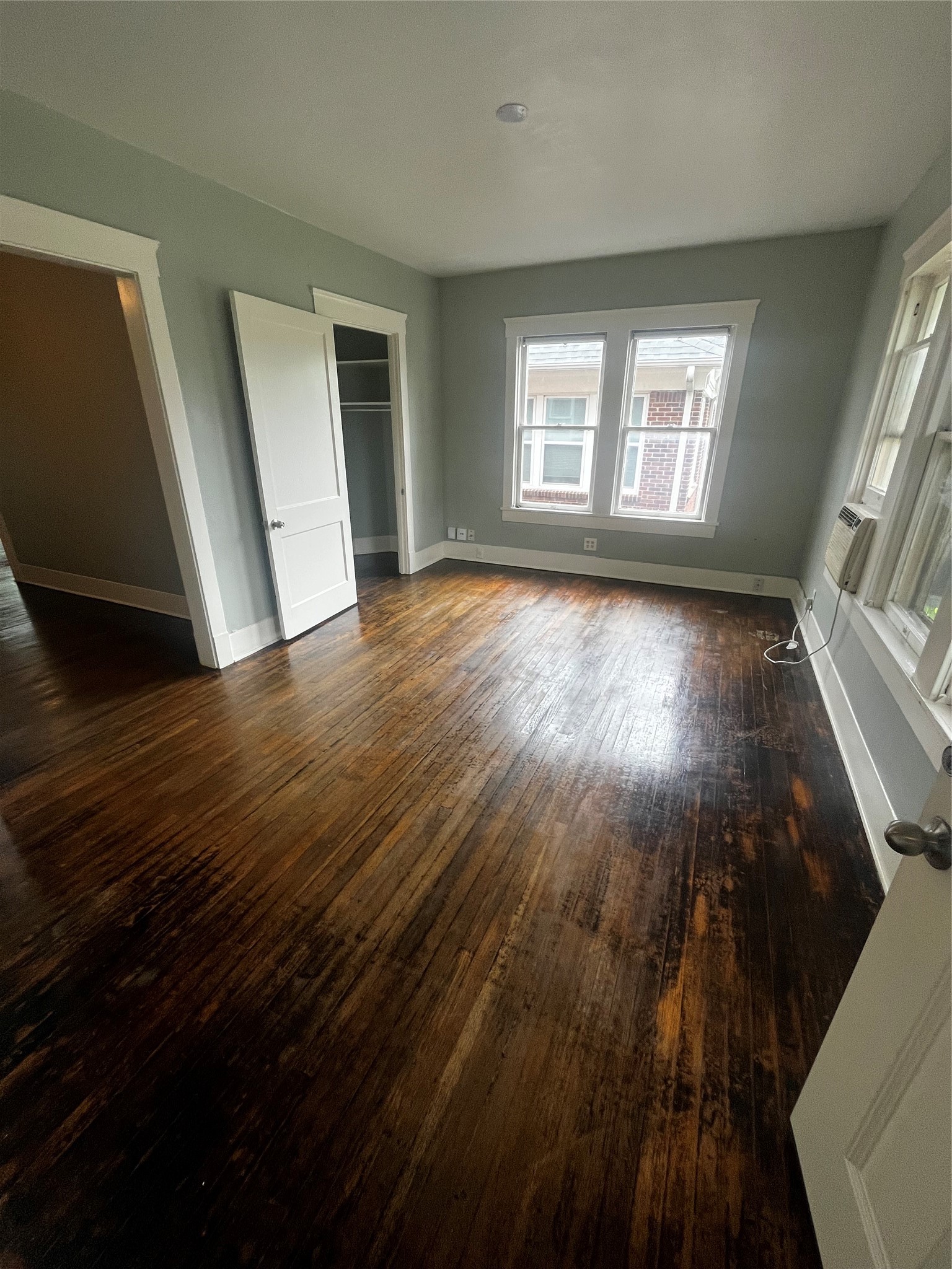 1711 West Main Street, Unit 3 Houston, TX 77098 - Photo 1 of 11 a view of an empty room with wooden floor and a window