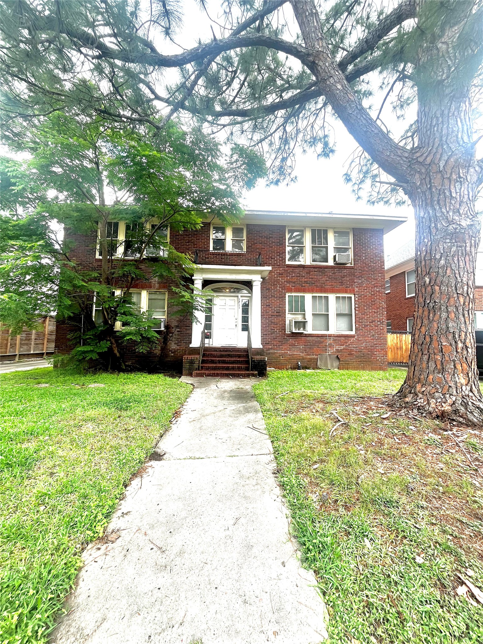 1711 West Main Street, Unit 3 Houston, TX 77098 - Photo 11 of 11 a front view of a house with a yard and trees