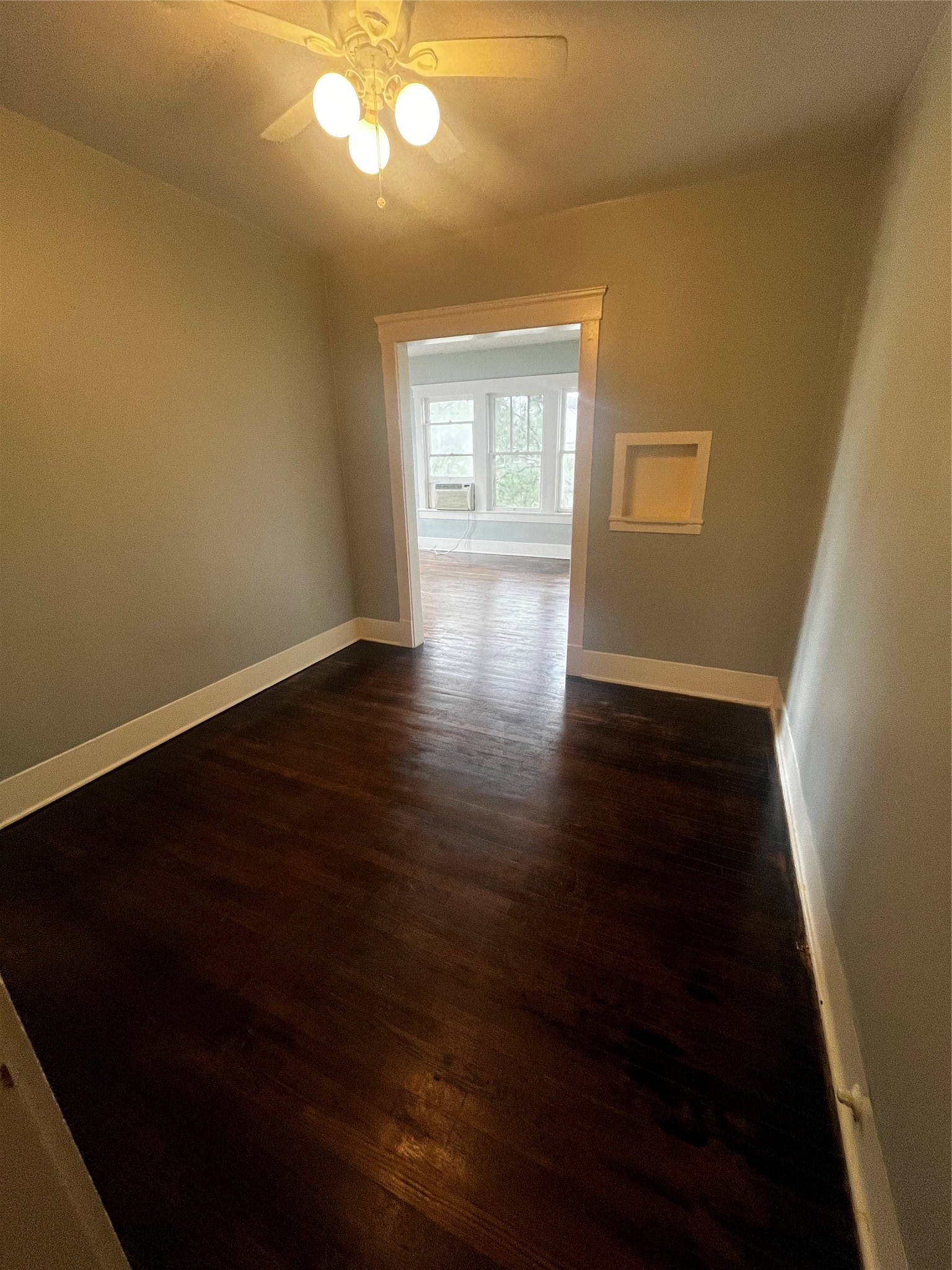 1711 West Main Street, Unit 3 Houston, TX 77098 - Photo 5 of 11 a view of an empty room with wooden floor and a window