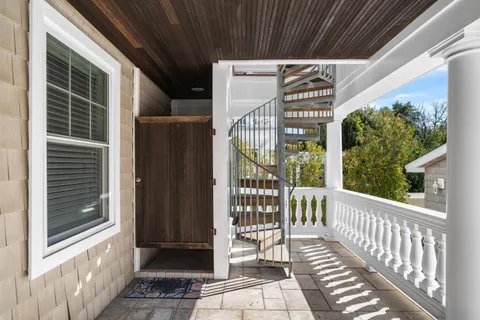 a view of a patio with a fireplace chairs and backyard