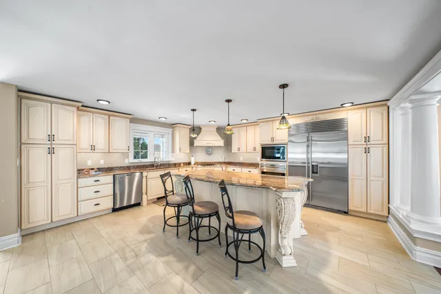 a dining room with furniture a chandelier and window