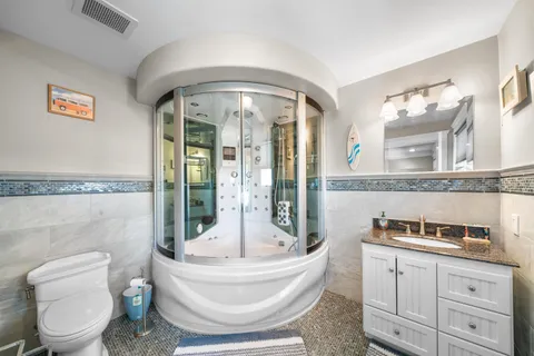 a spacious bedroom with a bed and a flat screen tv