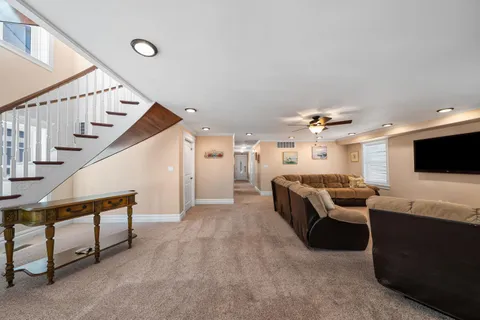 a bedroom with a bed a couch and a flat screen tv