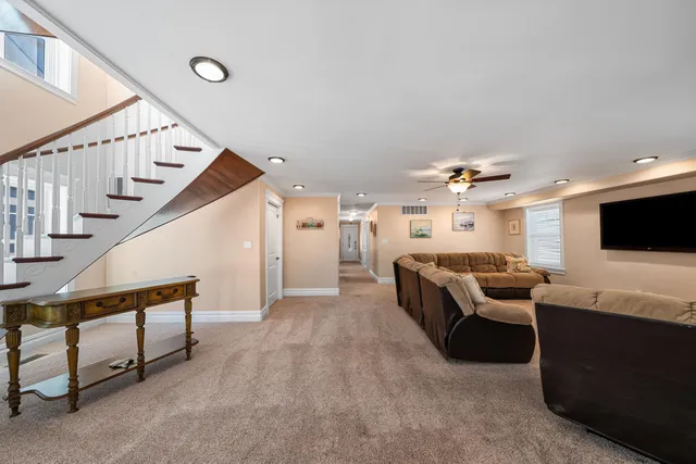 a bedroom with a bed a couch and a flat screen tv