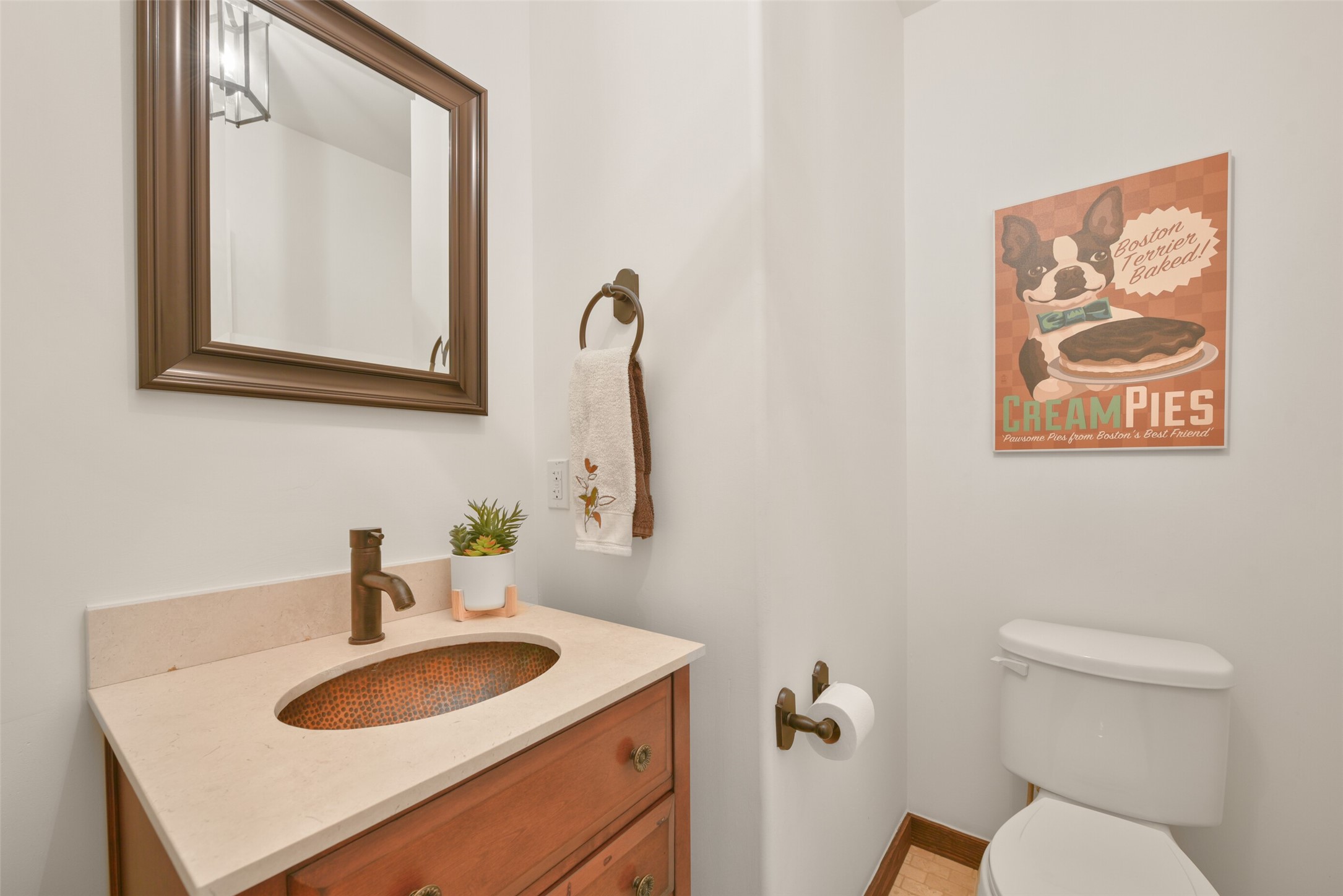 2601 Bevis Street, Unit B Houston, TX 77008 - Photo 10 of 25 Conveniently located on the 2nd floor just a few steps up from the main living area, this stylish powder room features a vanity with storage, elegant travertine tile flooring, and a decorative light fixture for added charm.
