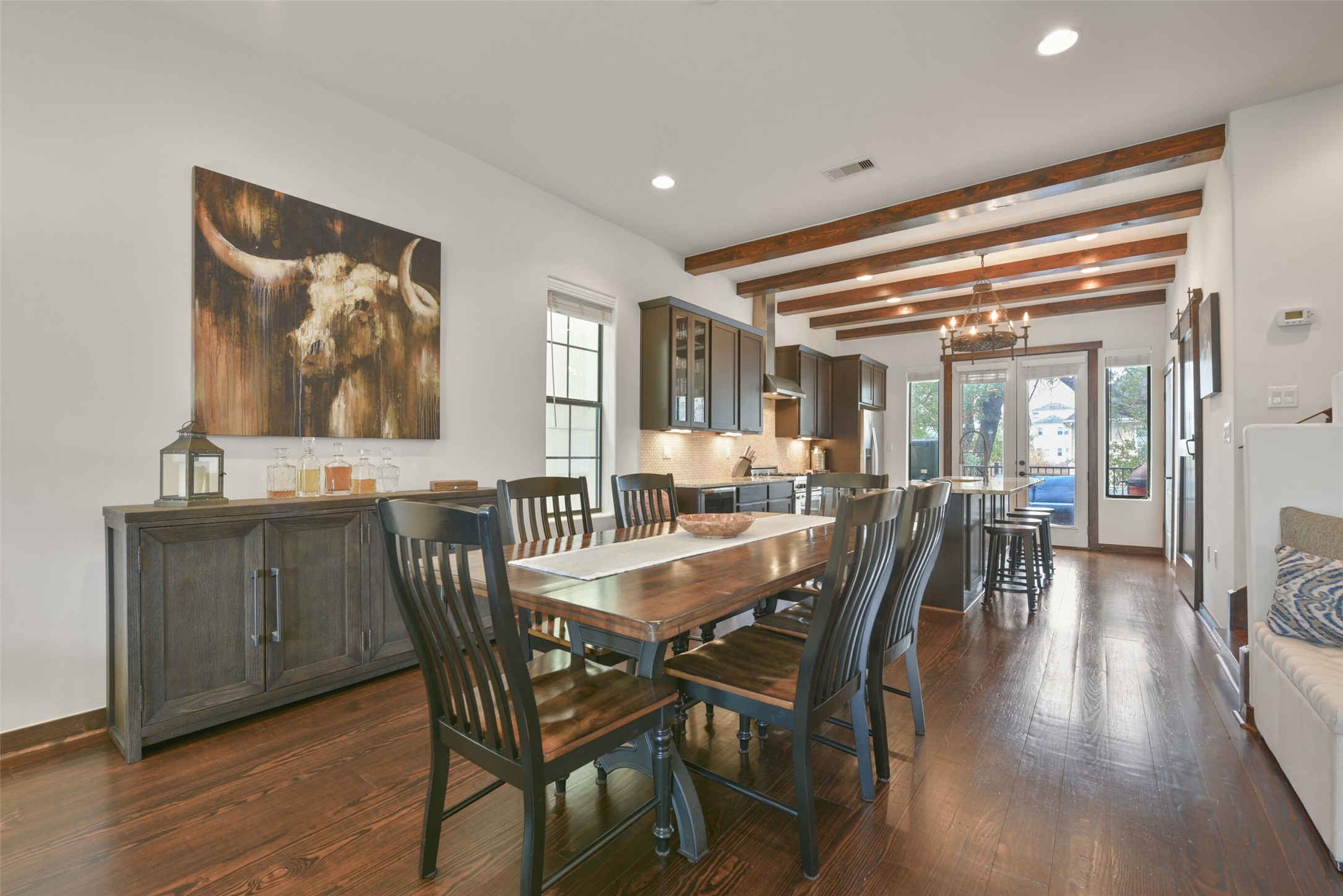 2601 Bevis Street, Unit B Houston, TX 77008 - Photo 5 of 25 The open-concept dining area seamlessly flows into the living room and kitchen, creating an ideal space for both everyday living and entertaining. Features include a ceiling outlet for a future dining light fixture, recessed can lighting, and windows with blinds. Ample space allows for additional furniture, like a buffet or sideboard, to personalize the room.