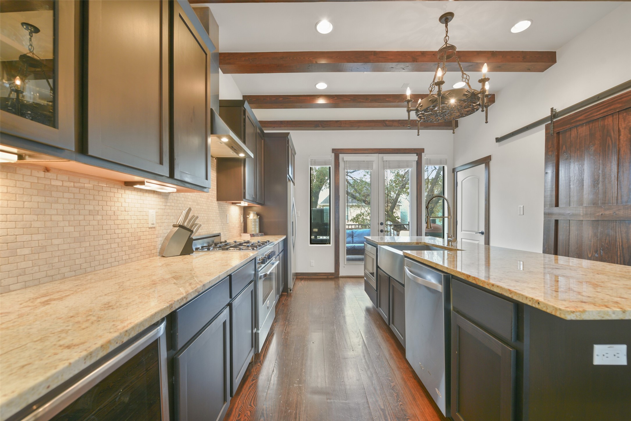 2601 Bevis Street, Unit B Houston, TX 77008 - Photo 9 of 25 Another look at this fabulous kitchen with tons of prep space and storage. The door on the right leads to the utility room with the washer and dryer (included), cabinets and dry hanging bar.