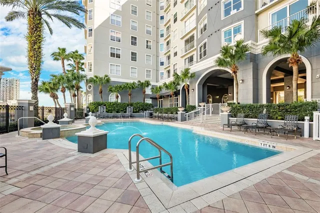 a view of swimming pool with outdoor seating and a ocean view