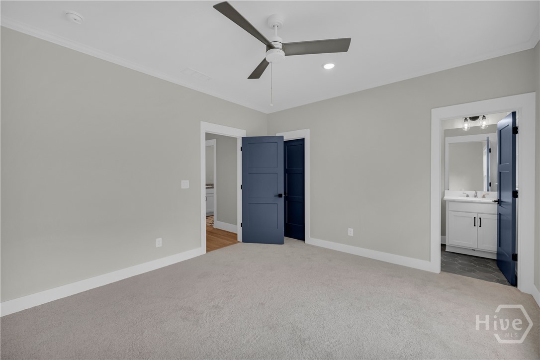 2476 St Martin Way Monroe, GA 30656 - Photo 55 of 75 Spacious En Suite Bedroom featuring light gray walls, white trim, and light gray carpeting