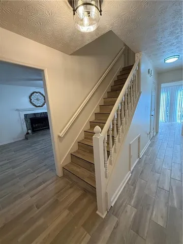 a view of entryway and hall with wooden floor