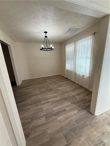 a view of a yard with wooden fence