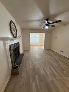 wooden floor in an empty room with a fireplace